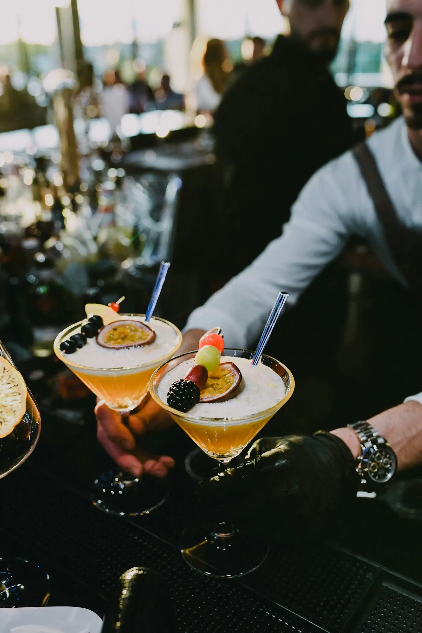 Friends raising cocktails together at the bar